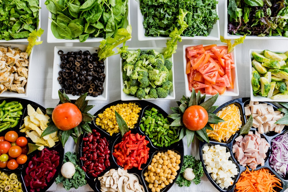 Fresh market produce with tomatoes, greens, and fresh fish